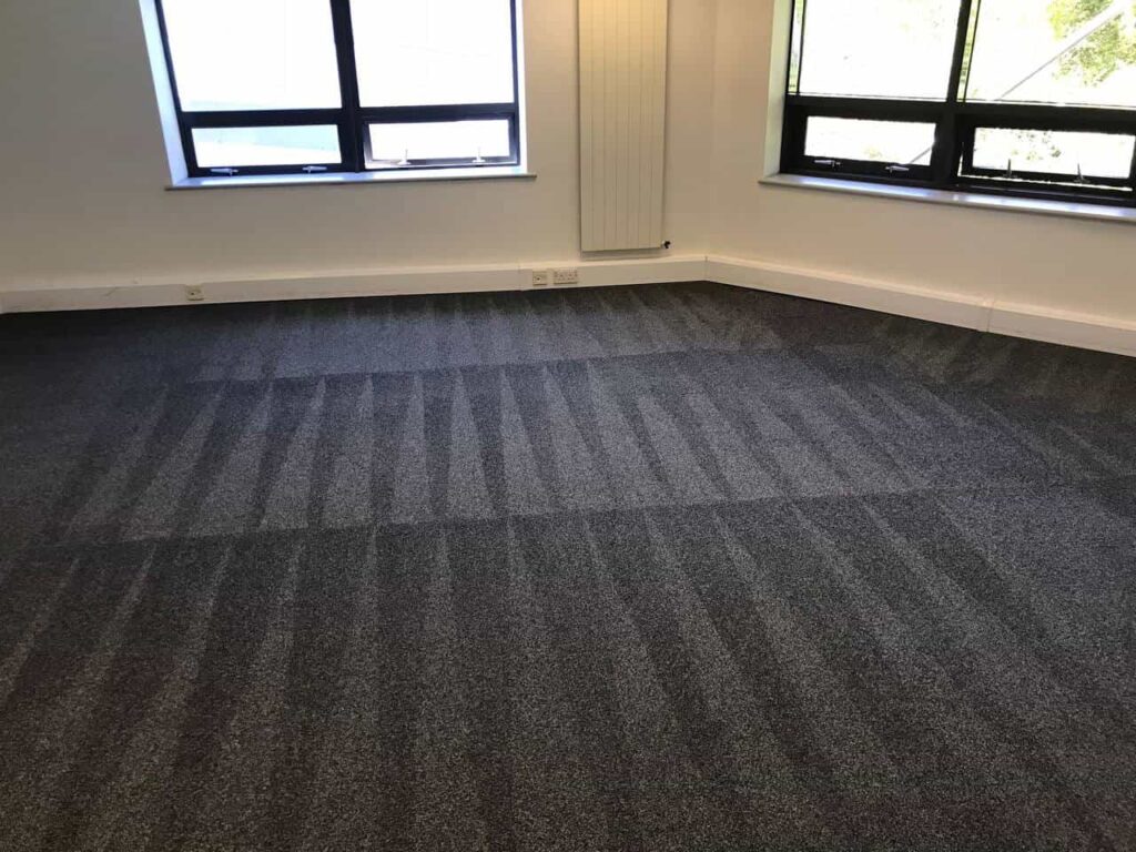 This is a photo of a grey office carpet that has just been professionally steam cleaned works carried out by Abbots Langley Carpet Cleaning