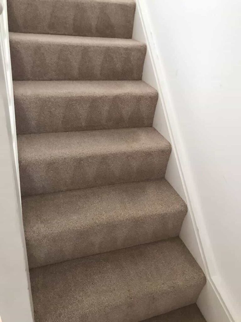 This is an after photo of a staircase with a beige carpet that has been cleaned works carried out by Abbots Langley Carpet Cleaning