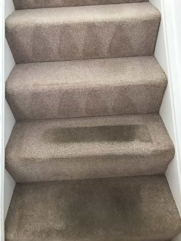 this is a photo of a staircase with beige carpets that is in the process of being cleaned works carried out by Abbots Langley Carpet Cleaning